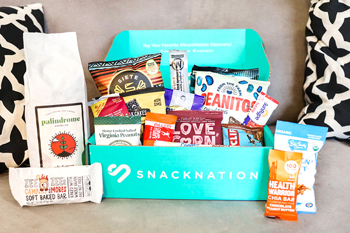 Assorted healthy snacks and a SnackNation box.